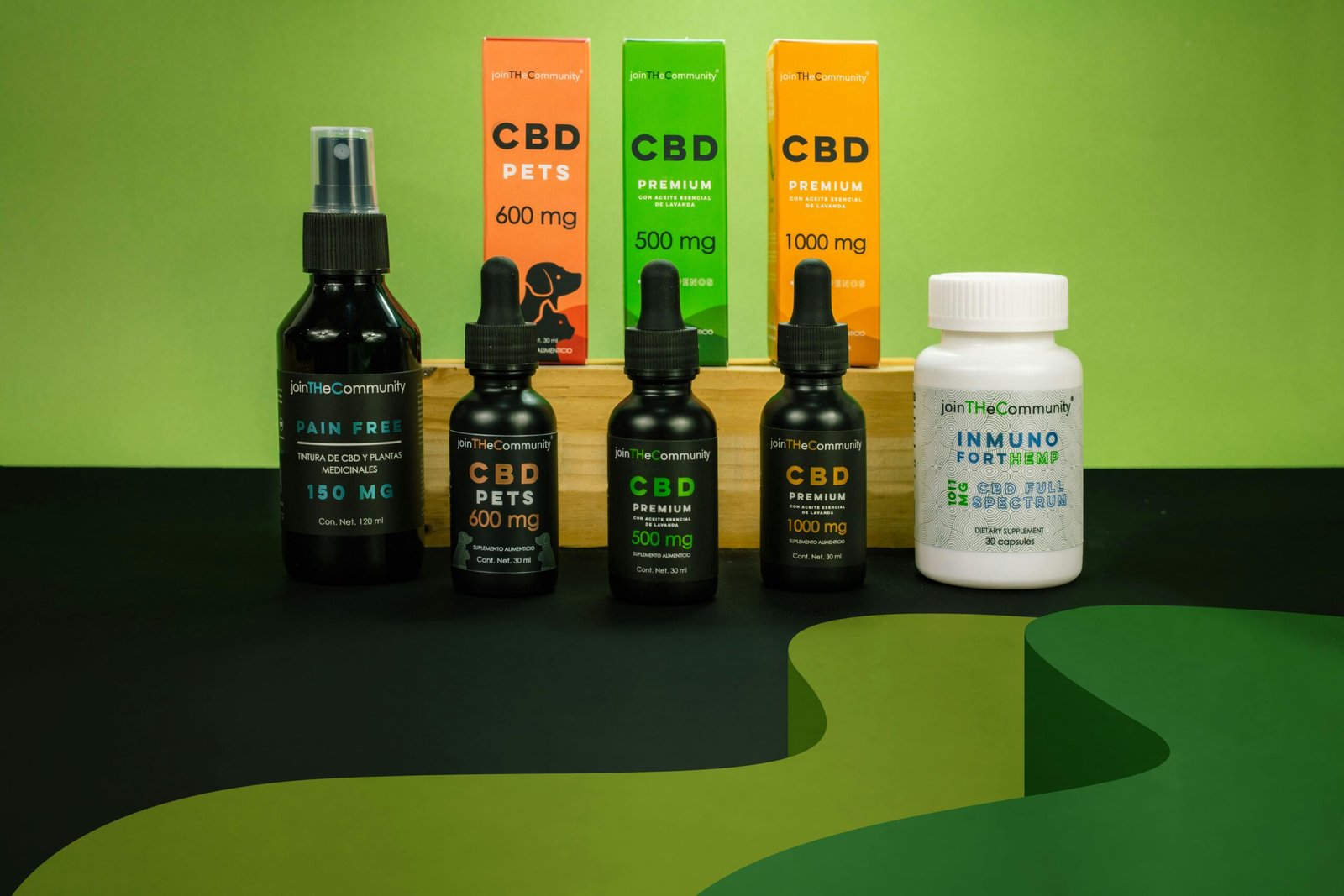 Array of CBD products including oils and supplements on a green background.